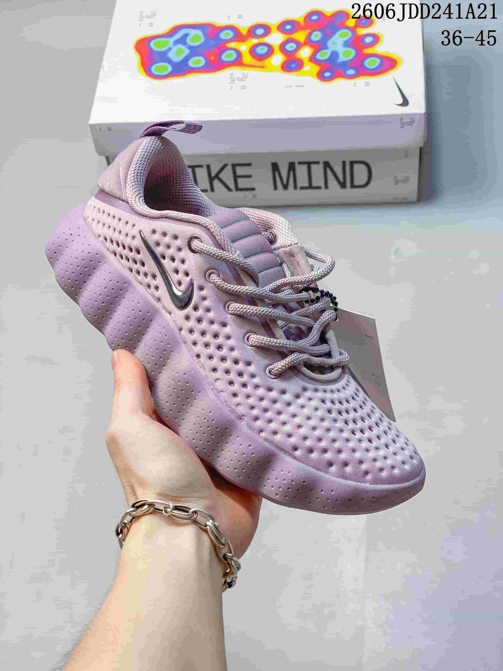 Pale purple Nike Mind 002 SP FK shoe with a dimpled upper and sculpted outsole.