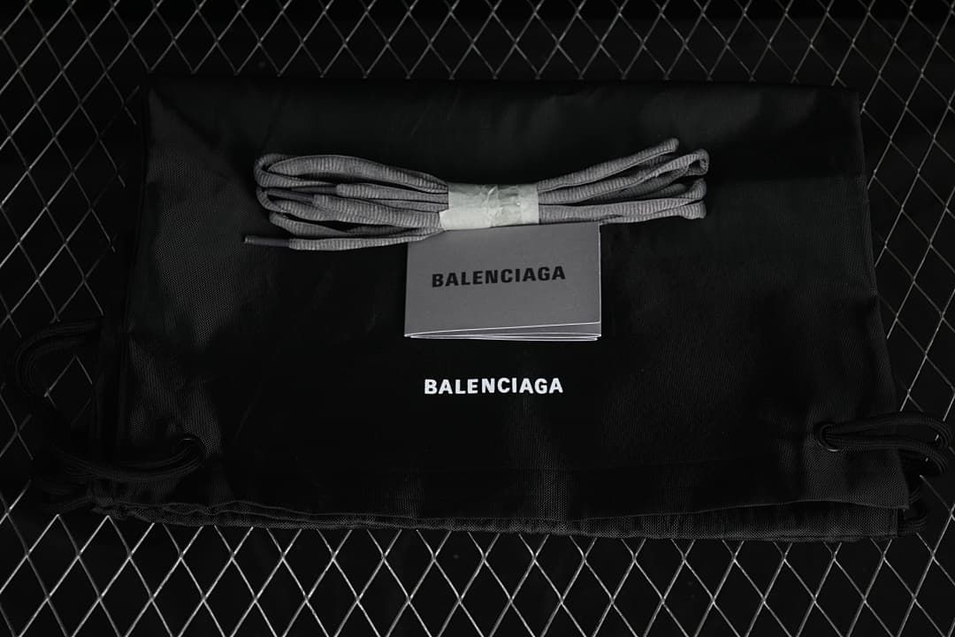 Gray lace bundle, booklet, and black drawstring bag shown with Balenciaga branding