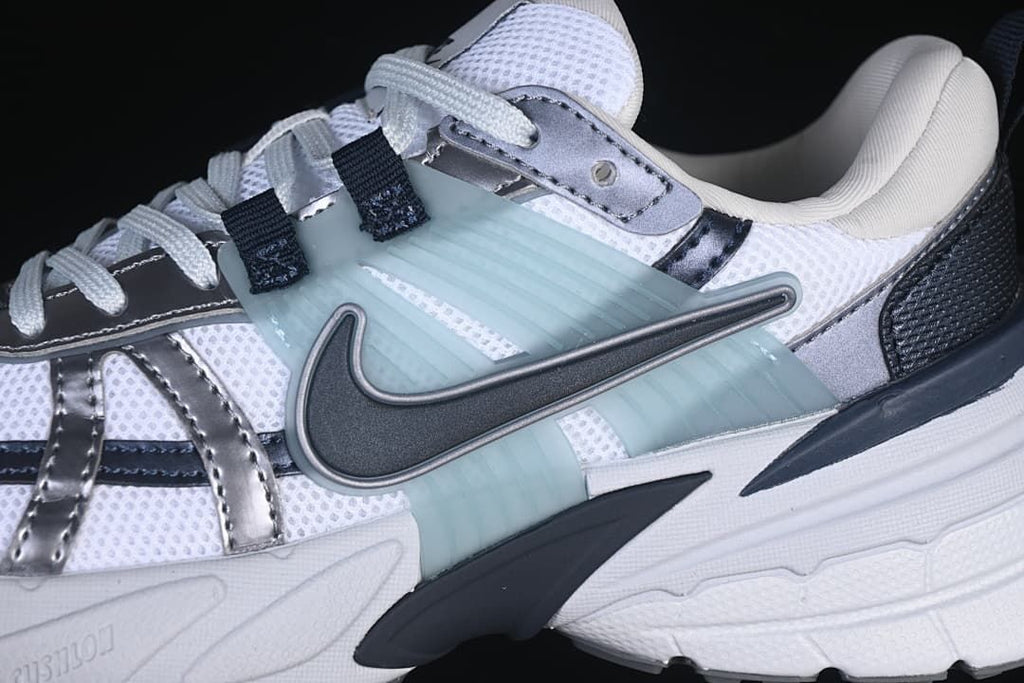 Close-up of the side panels, metallic-look overlays, and pale aqua accent.