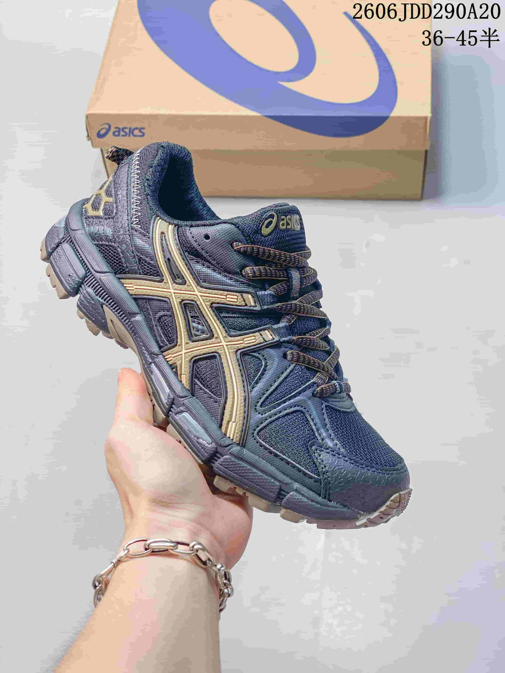 ASICS Gel-Kahana 8 sneaker in dark navy and grey with gold-tone accents.