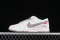Side view of white Nike SB Dunk Low sneakers with mauve accents and Supreme and The North Face graphics