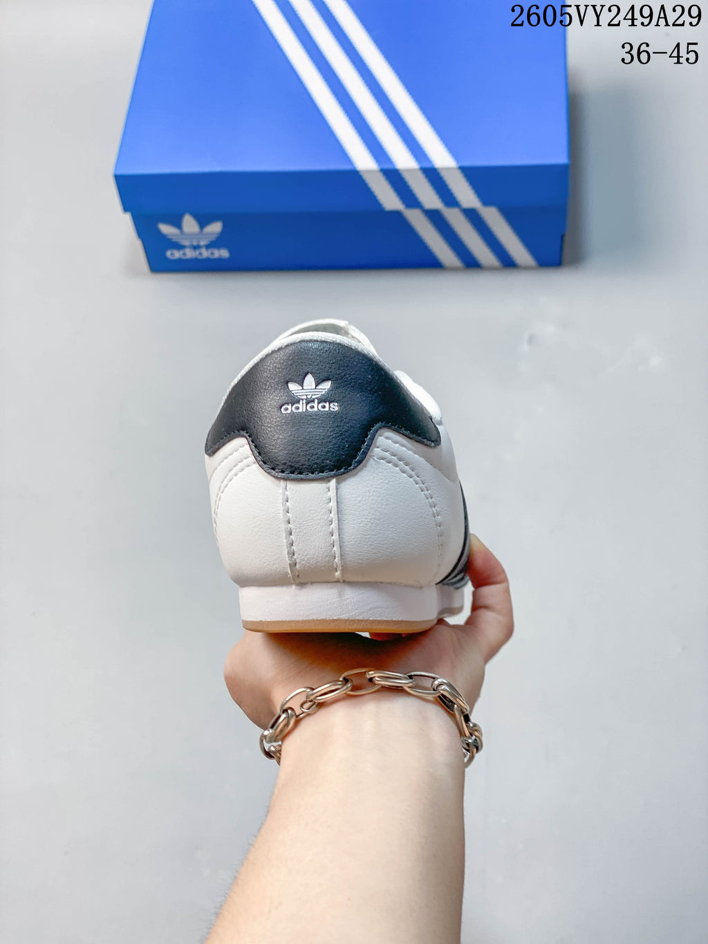 Rear view showing the dark heel accent and logo on a white sneaker