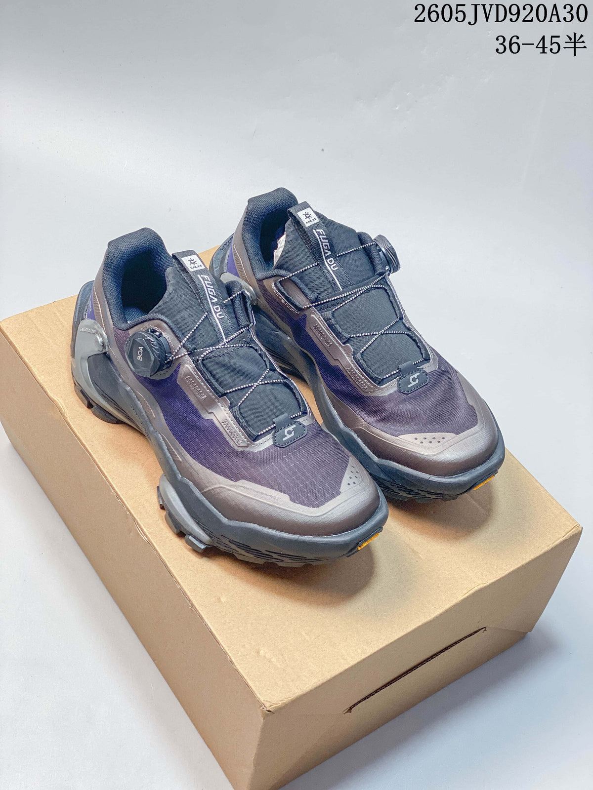Pair of gray and purple Kailas FUGA DU2 BOA trail shoes, shown from the front with rotary closures and lugged soles.