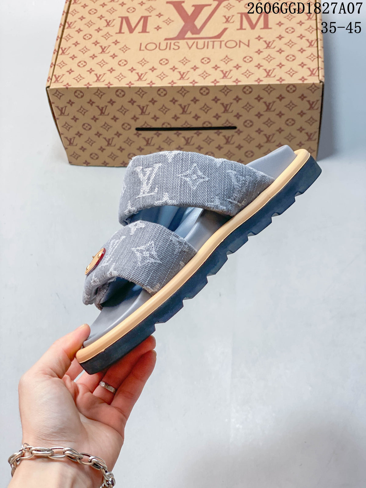 Side profile of a gray two-strap slide sandal with a dark outsole.