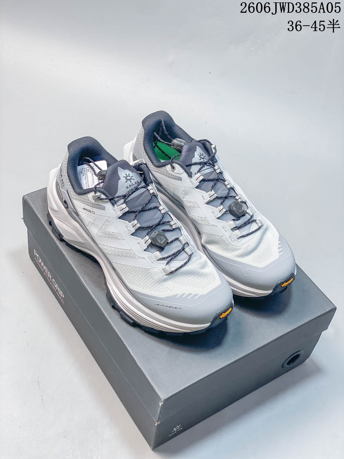 Pair of gray and white Kailas Fuga Ex3 trail shoes with dial-adjustable laces