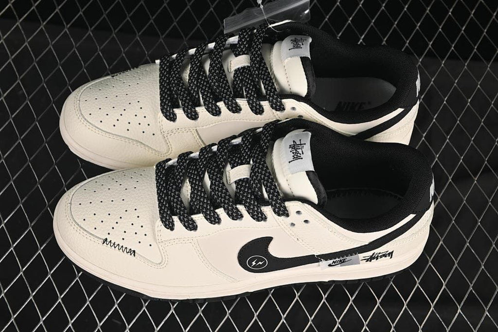 Top view of a pair of cream low-top sneakers with patterned black laces