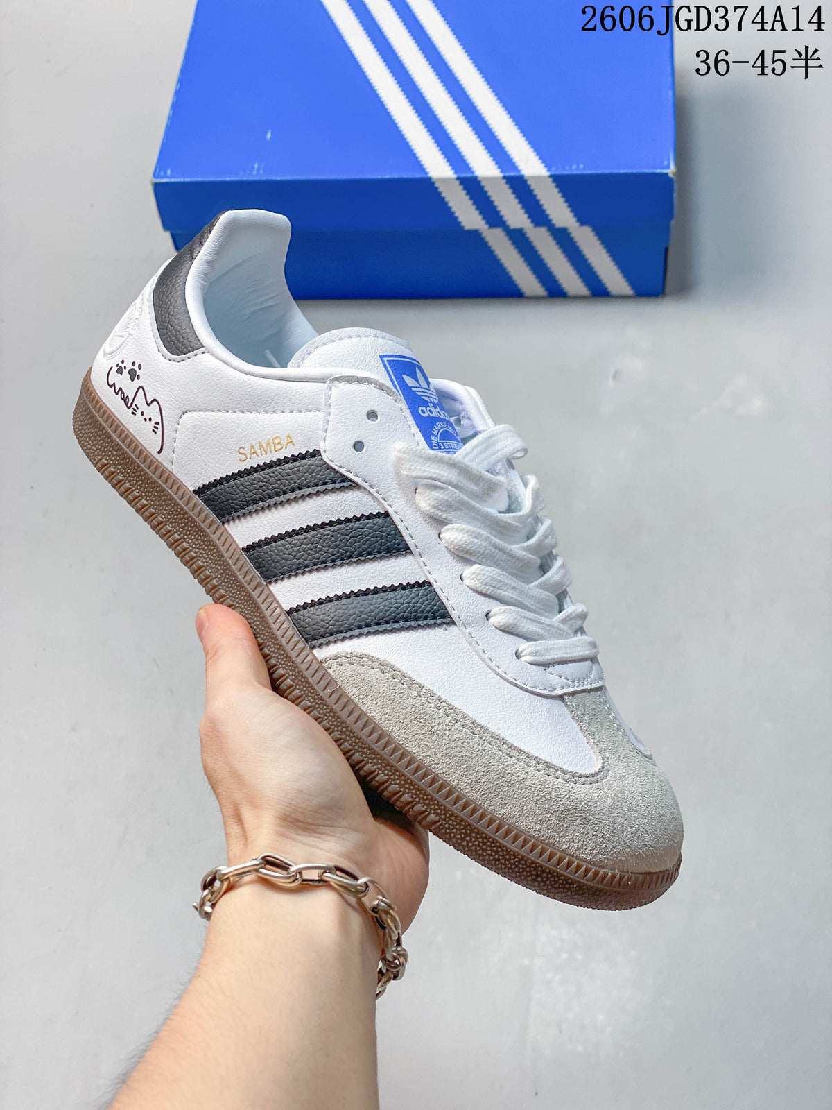 White low-top sneaker with dark gray stripes, suede-look toe overlay, and gum sole.