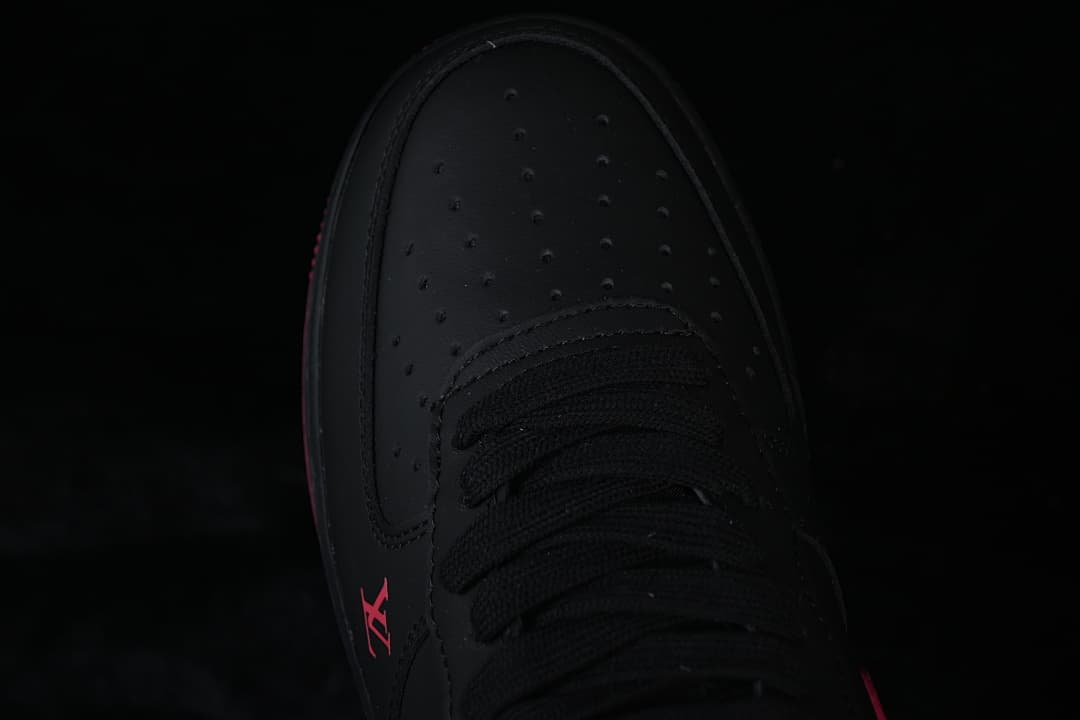 Top-down close-up of the perforated black toe and laces