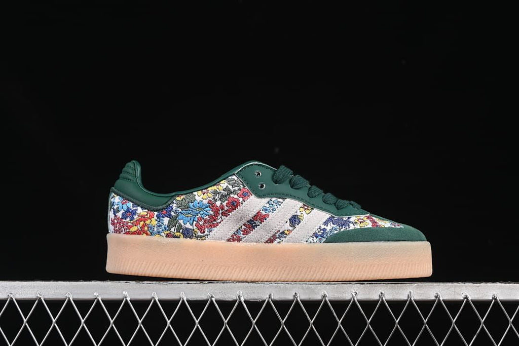Side profile of a green sneaker with floral-patterned panels and a gum-toned sole.