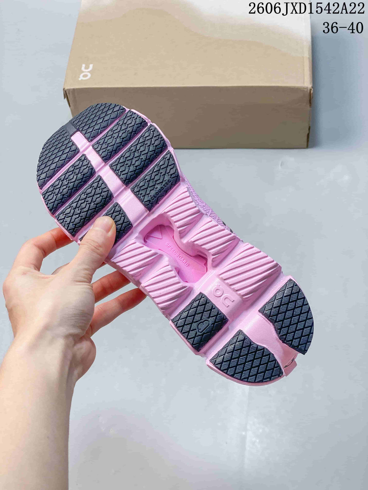 View of the segmented pink sole with dark outsole sections