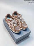 Pair of brown, beige, and pale pink New Balance 204L sneakers on a shoe box