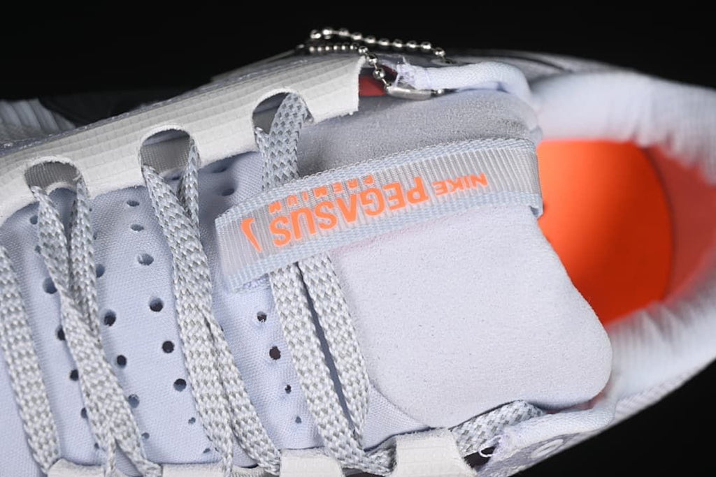 Close-up of laces, tongue, and orange tongue branding