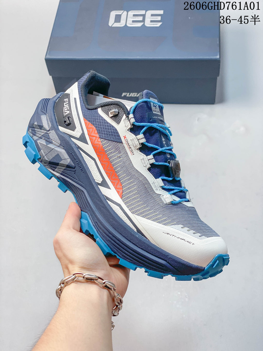 Side profile of a Kailas FUGA EX330 II trail running shoe in gray, navy, white, orange, and blue.