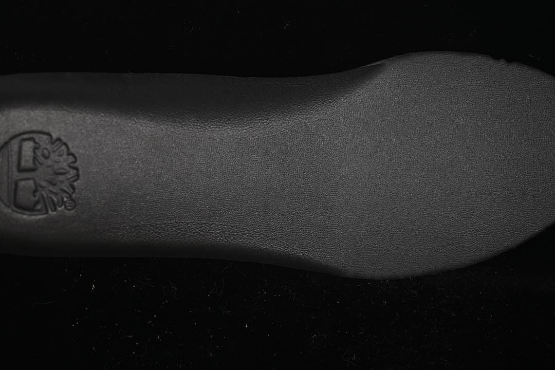 Close-up of the dark outsole surface and Timberland tree logo.