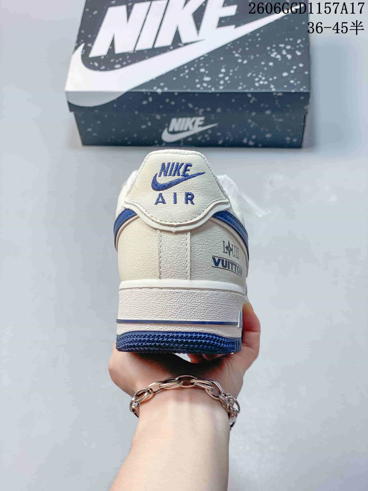 Rear view showing embroidered heel details and blue outsole
