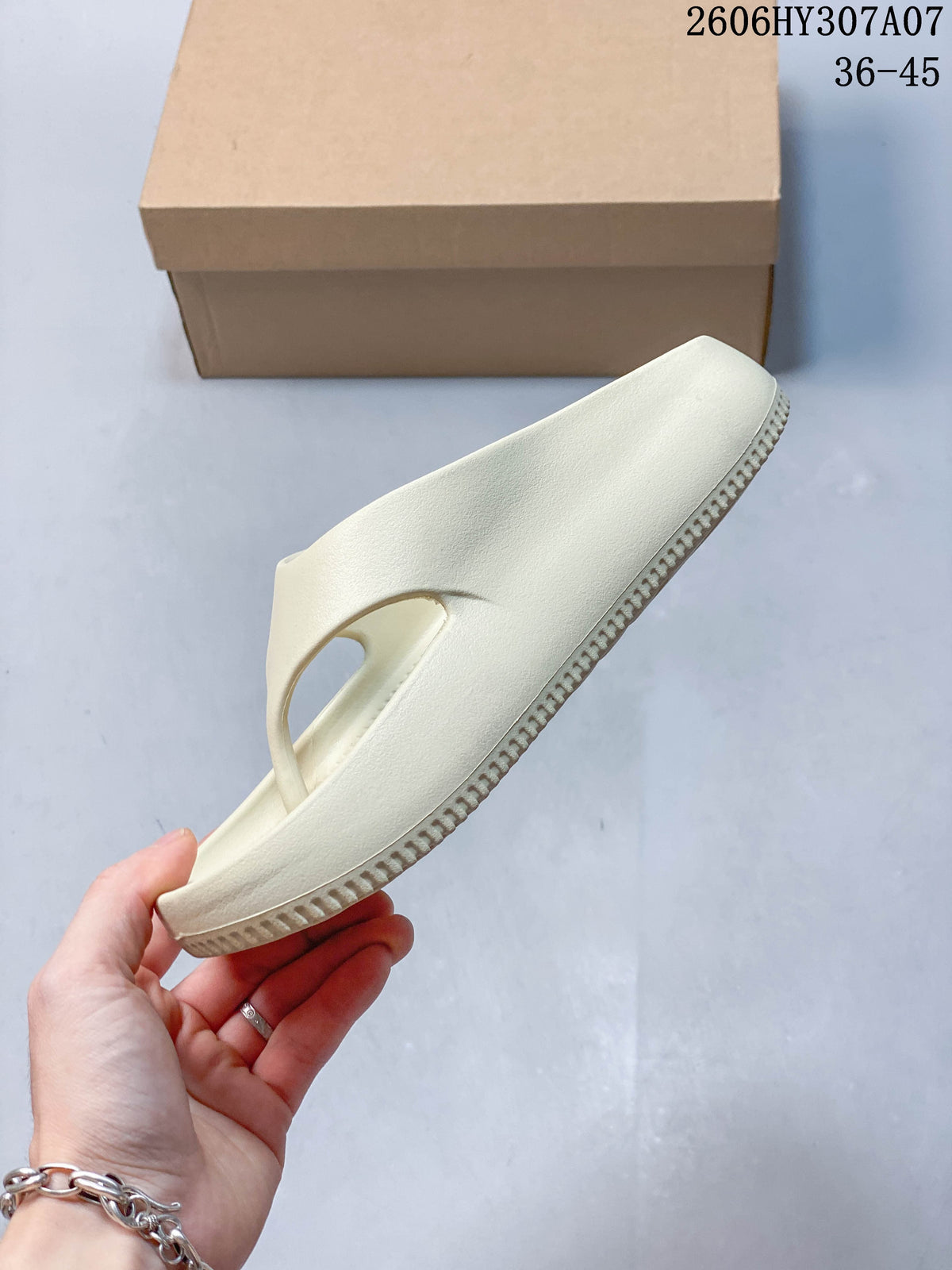Side profile showing the sandal's broad strap and textured sole