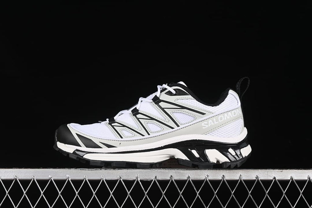 Side view of a white, metal, and black Salomon XT-6 Expanse sneaker.