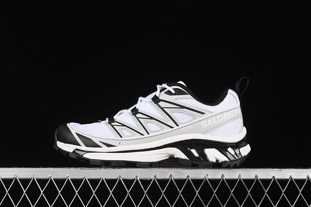Side view of a white, metal, and black Salomon XT-6 Expanse sneaker.