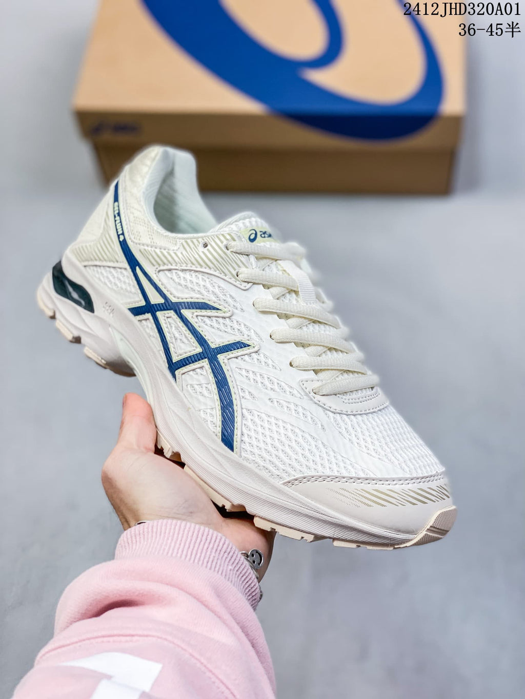 Angled side view of the white and blue shoe with a patterned outsole.