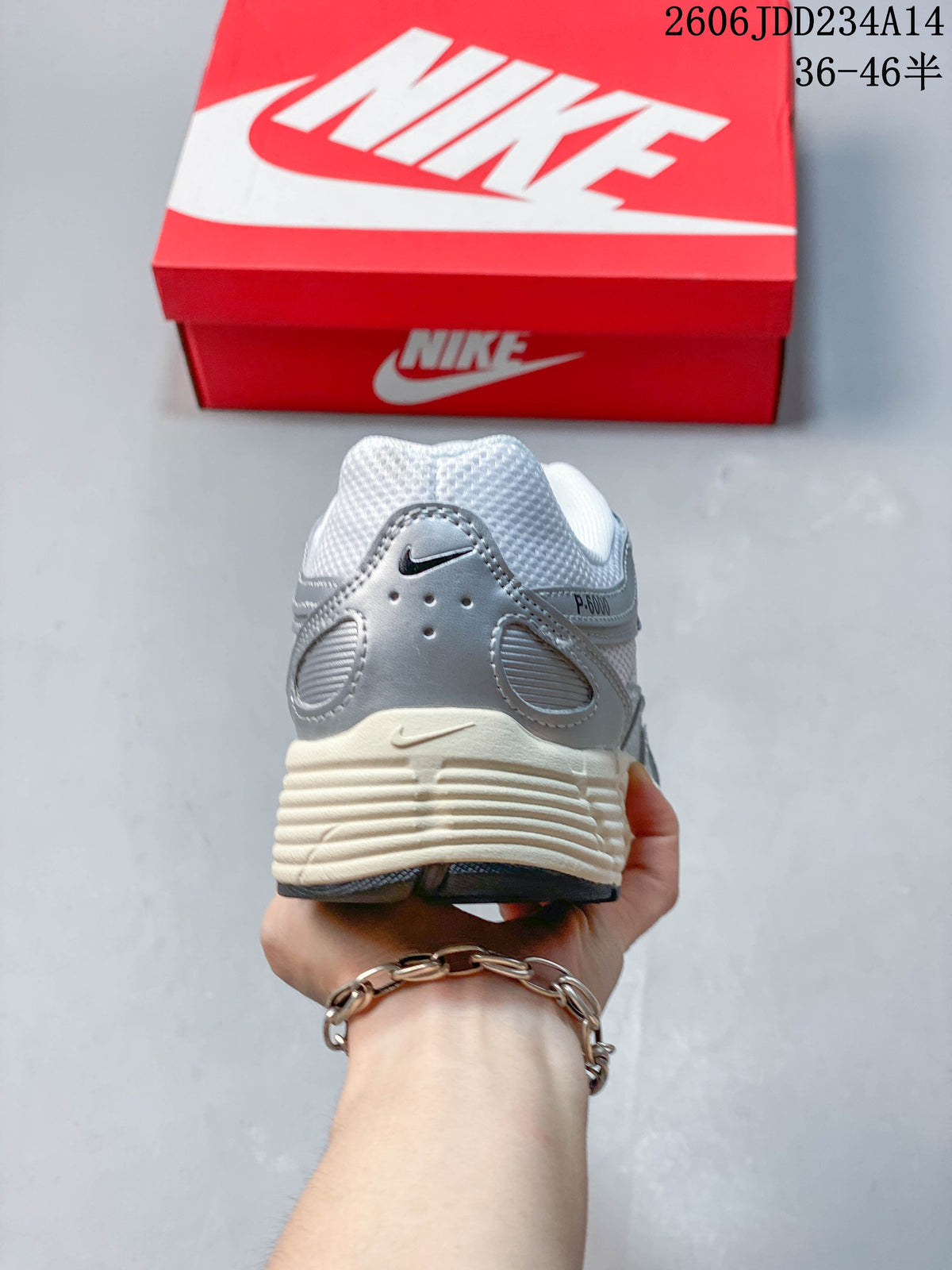 Rear view showing the layered heel panels and off-white midsole