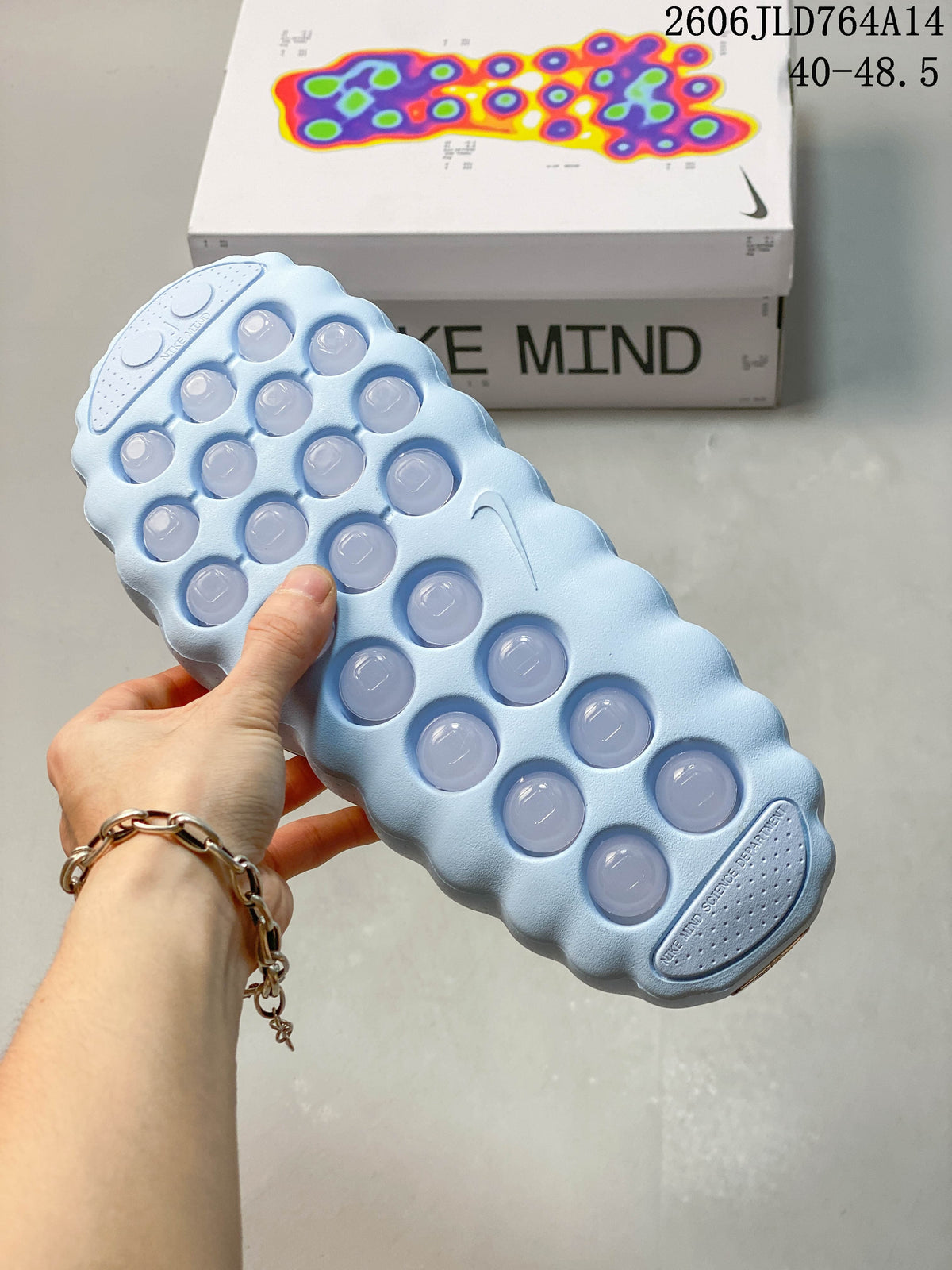 Close-up of the sculpted outsole with raised circular details on a light blue mule