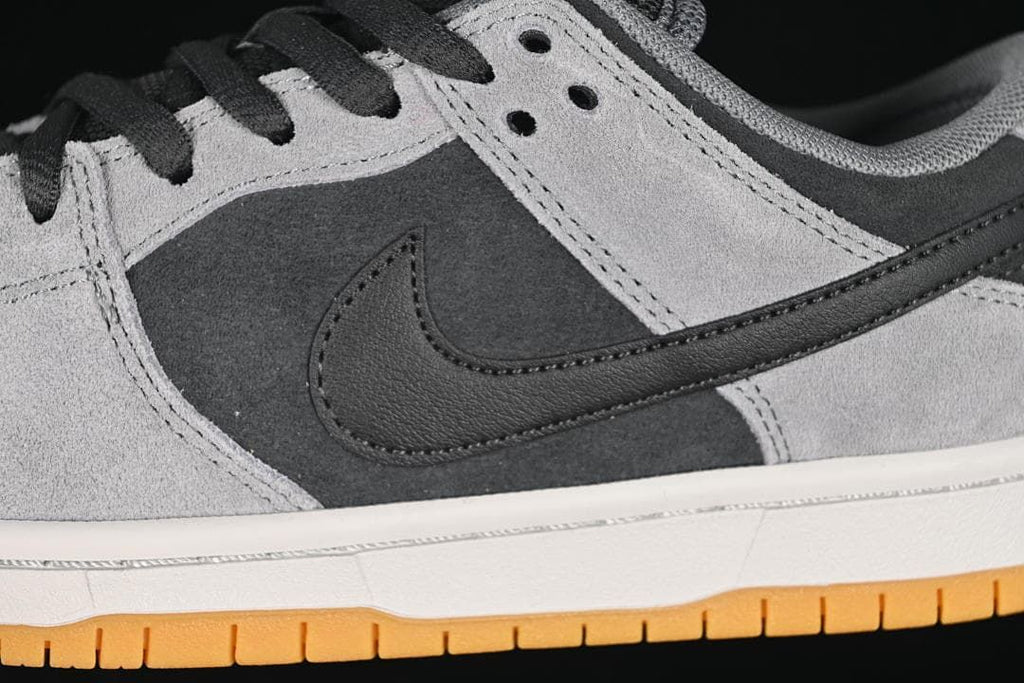 Close-up of the black side logo and contrasting grey and charcoal panels