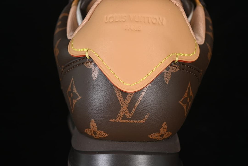 Rear view showing the tan heel tab and patterned brown upper.