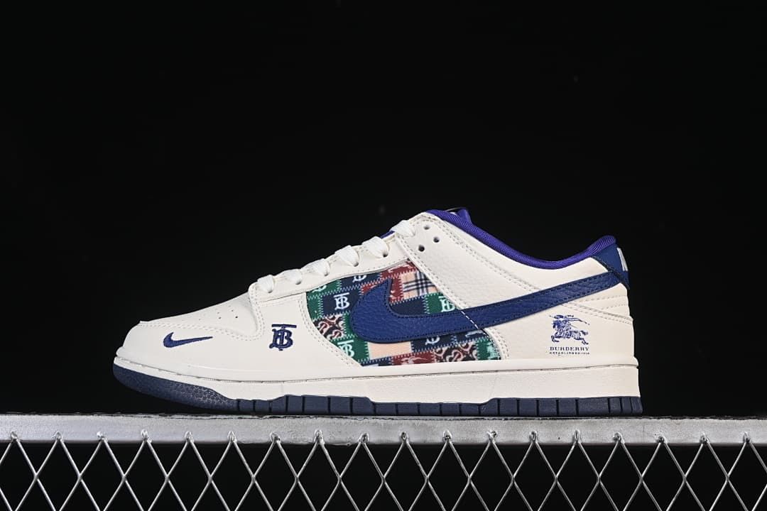 Side view of a white and blue low-top sneaker with a multicolored patterned panel and branded details.