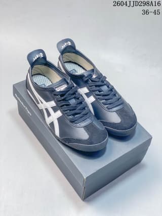 Pair of navy and white ASICS Tiger Mexico 66 sneakers displayed on top of the shoe box.