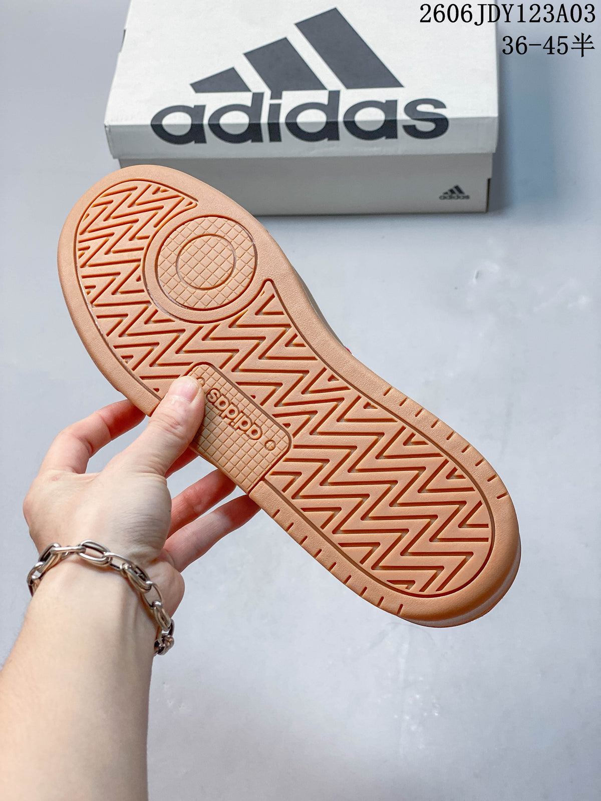 Underside of a gum-colored sneaker sole showing its patterned tread