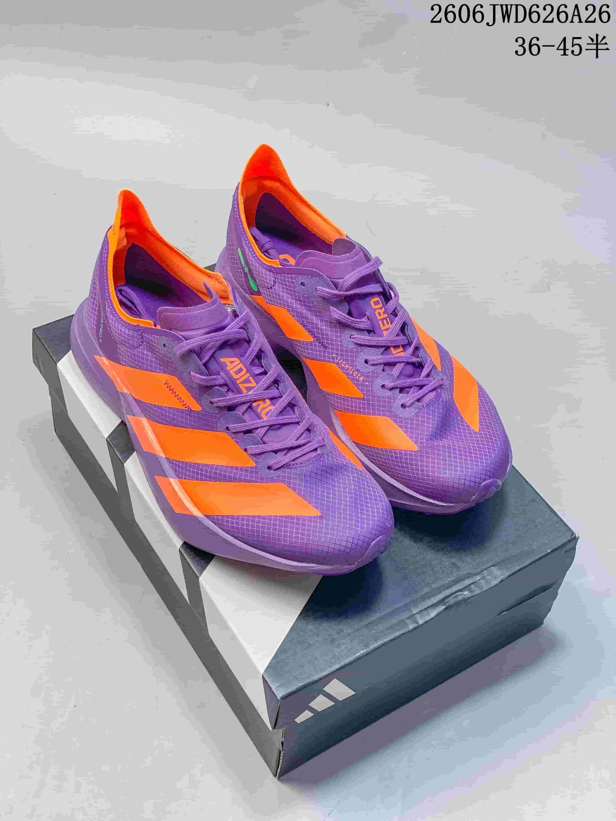 Purple and orange Adidas Adizero Adios Pro 4 shoes displayed on a box.