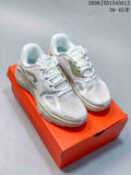Pair of white and pale green Nike Structure Plus running shoes on an orange shoebox