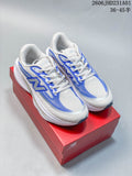 Pair of white and blue New Balance Ellipse v1 running shoes on a red shoebox