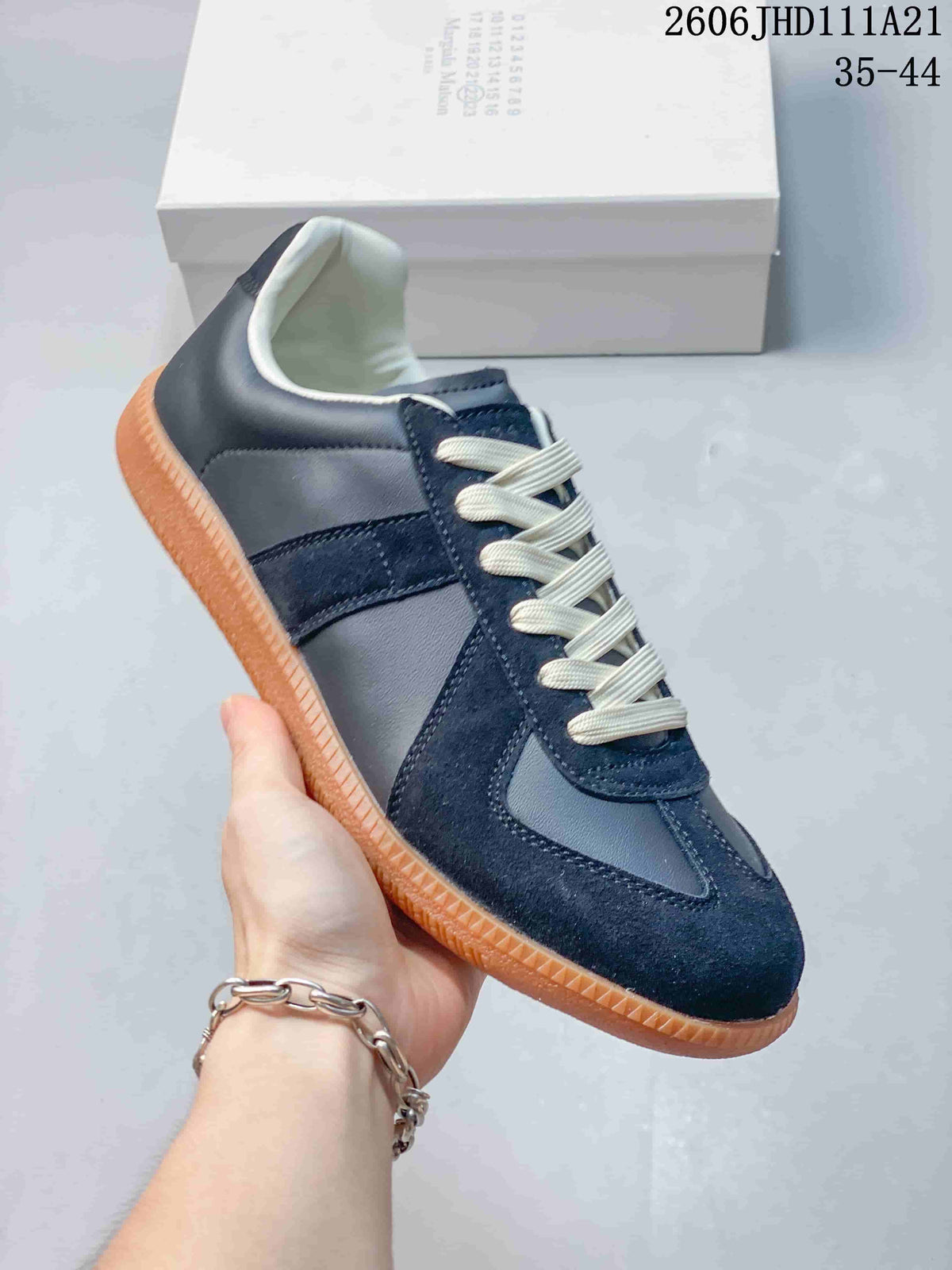 Angled side view of the navy low-top sneaker with cream laces