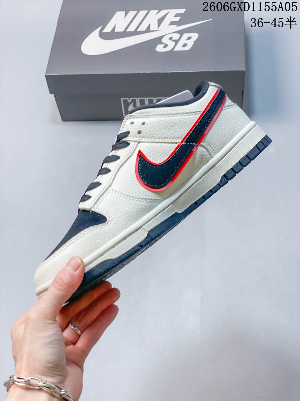 Side profile showing cream panels, navy side logo and red edging