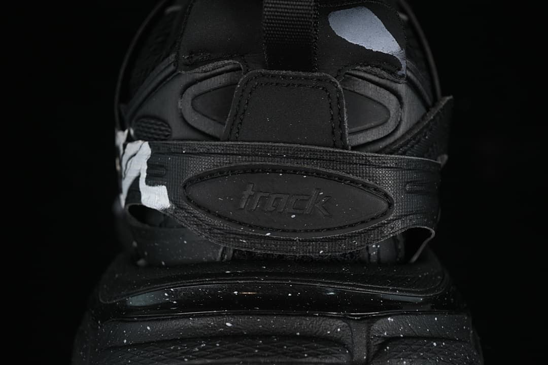 Rear close-up of the sneaker with a branded heel strap and sculpted sole.