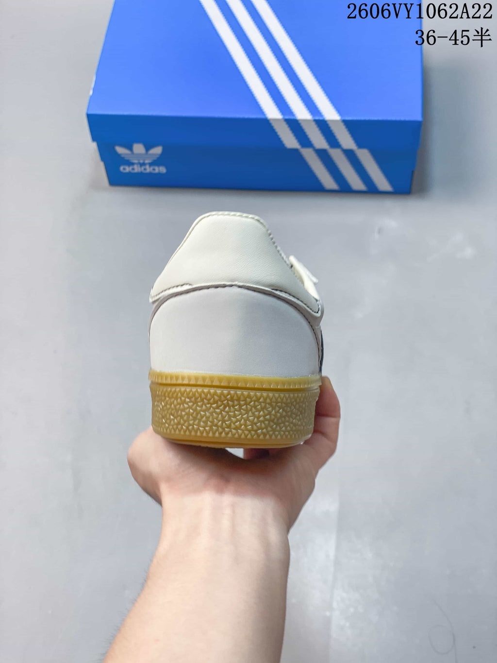 Rear view of the white sneaker and gum-colored heel outsole