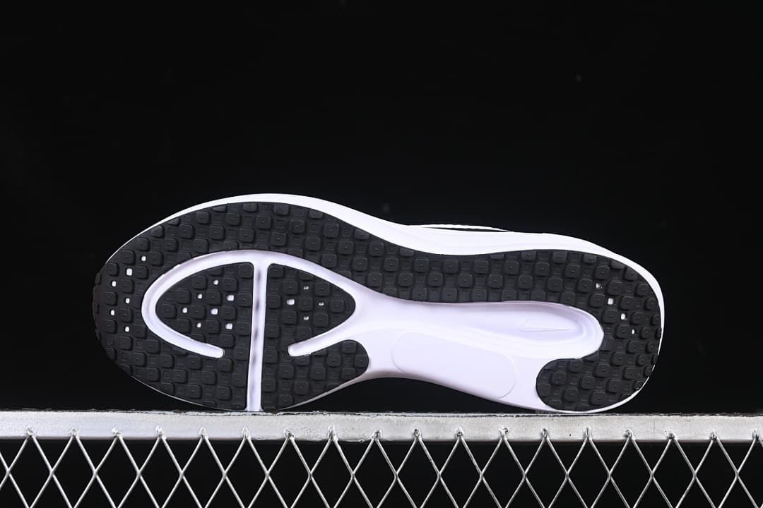 Underside view showing the black patterned outsole and white midfoot section