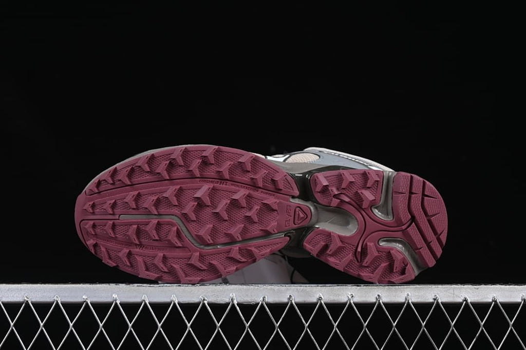 Underside view of the pair showing the patterned berry-colored outsoles.