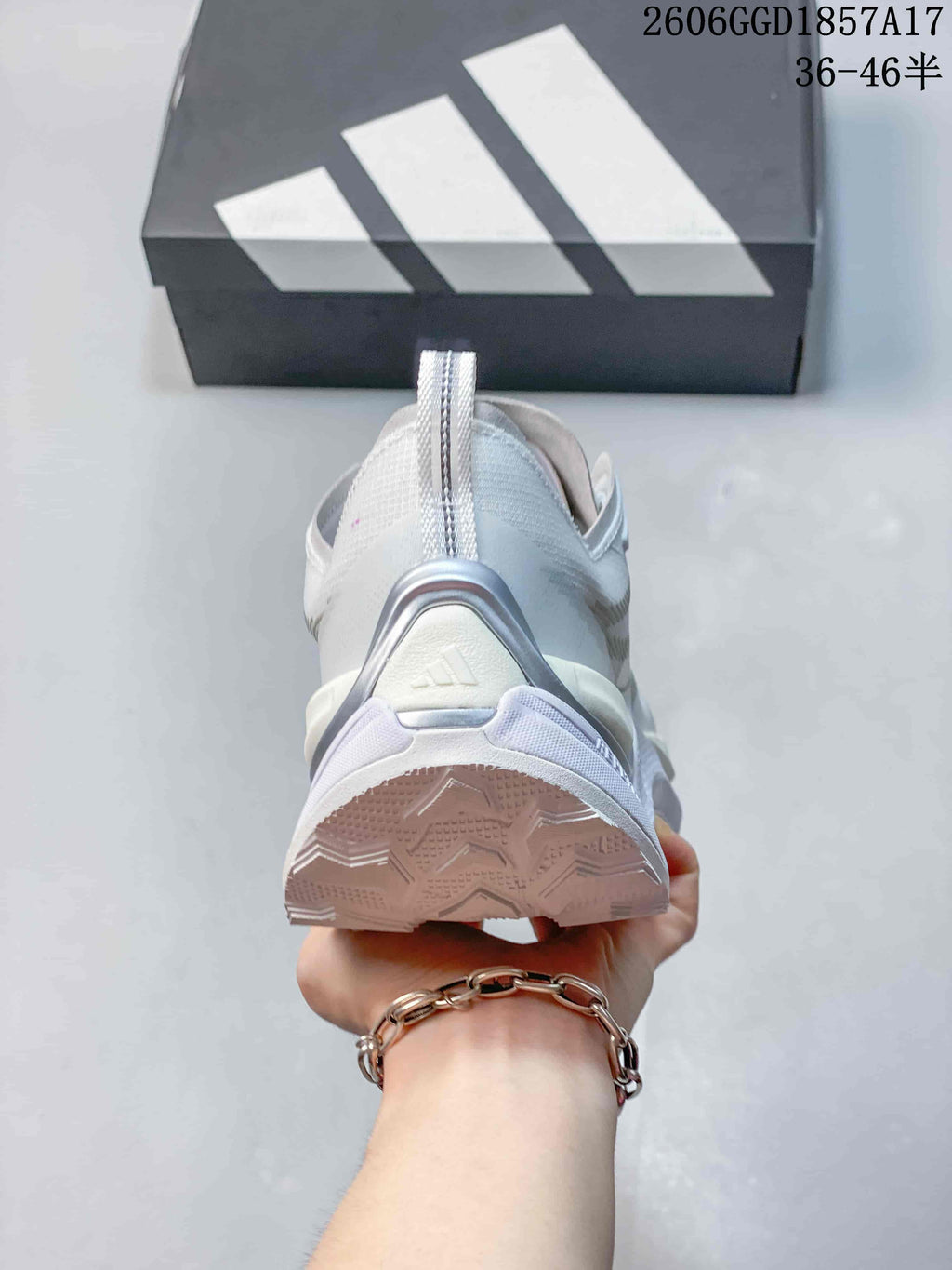 Rear view of a white Adidas shoe showing the heel and outsole