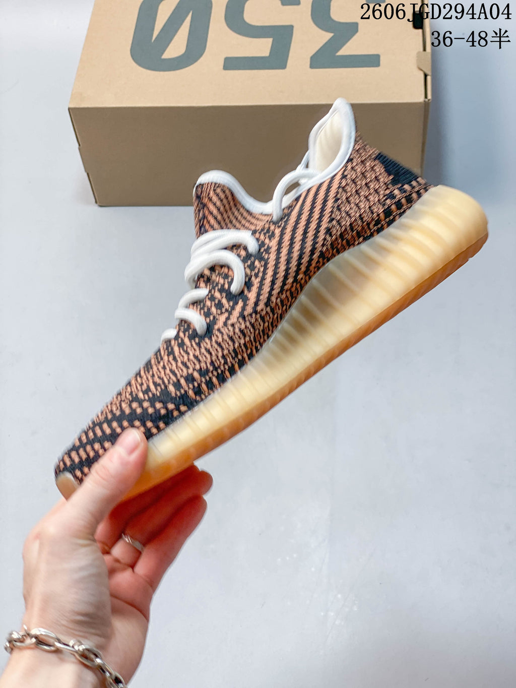 Side view of the patterned sneaker and ribbed amber-toned outsole