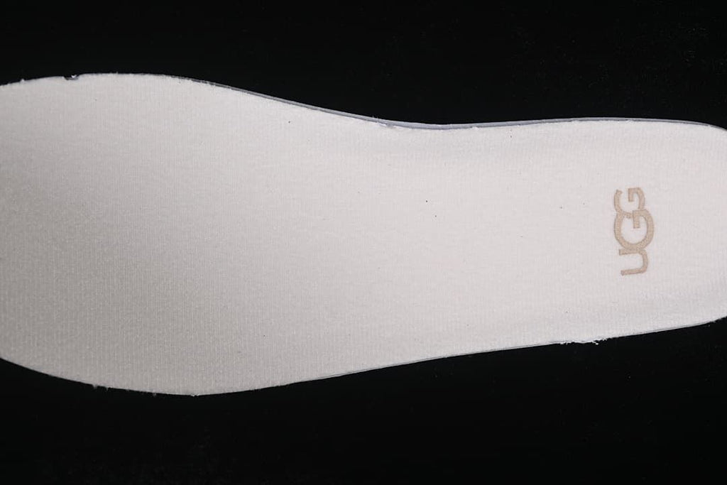 Close-up of the light-colored sneaker insole with UGG logo