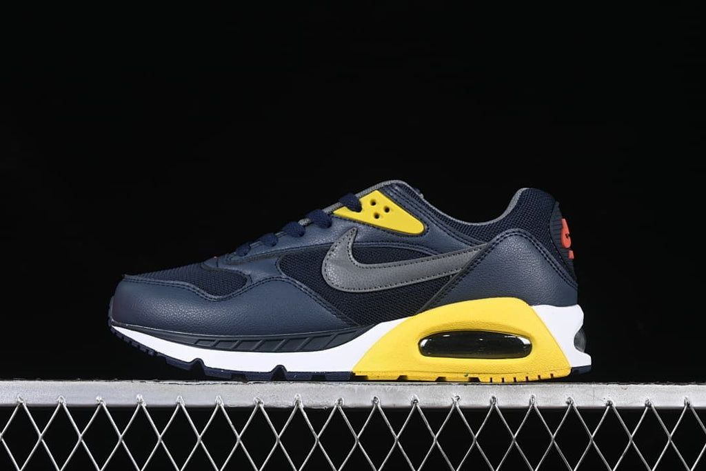 Side view of navy Nike Air Max Correlate sneakers with gray, yellow, and white accents.