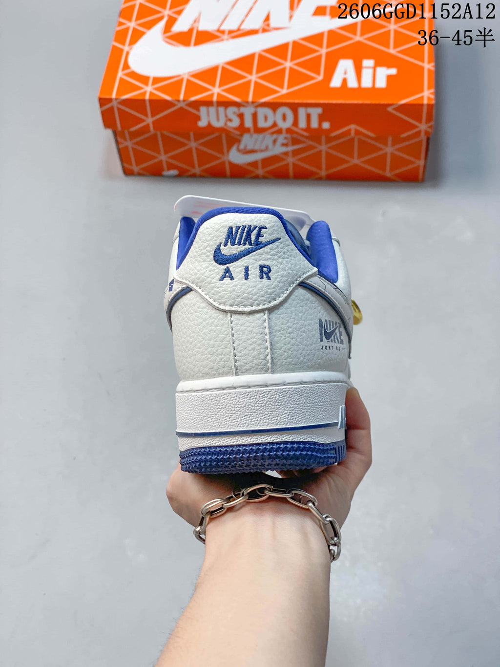 Rear view of the sneaker showing blue heel branding and outsole