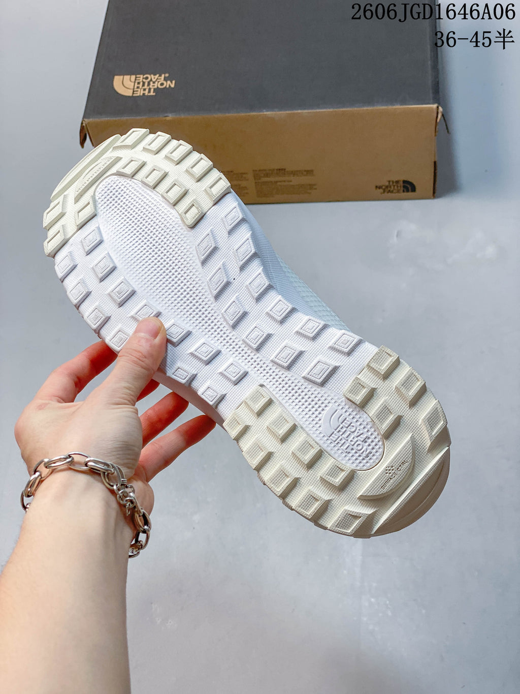 Close-up of the white shoe’s chunky tread outsole.