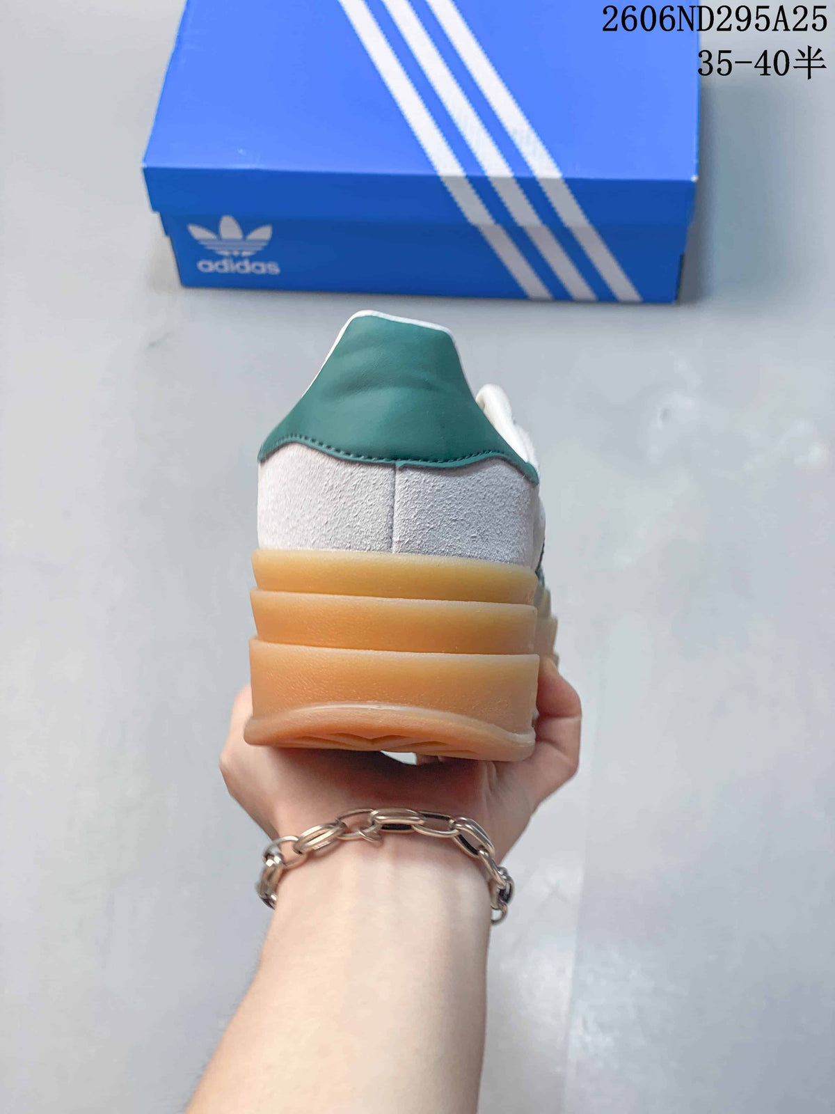 Rear view showing the layered gum-colored platform sole and green heel detail.
