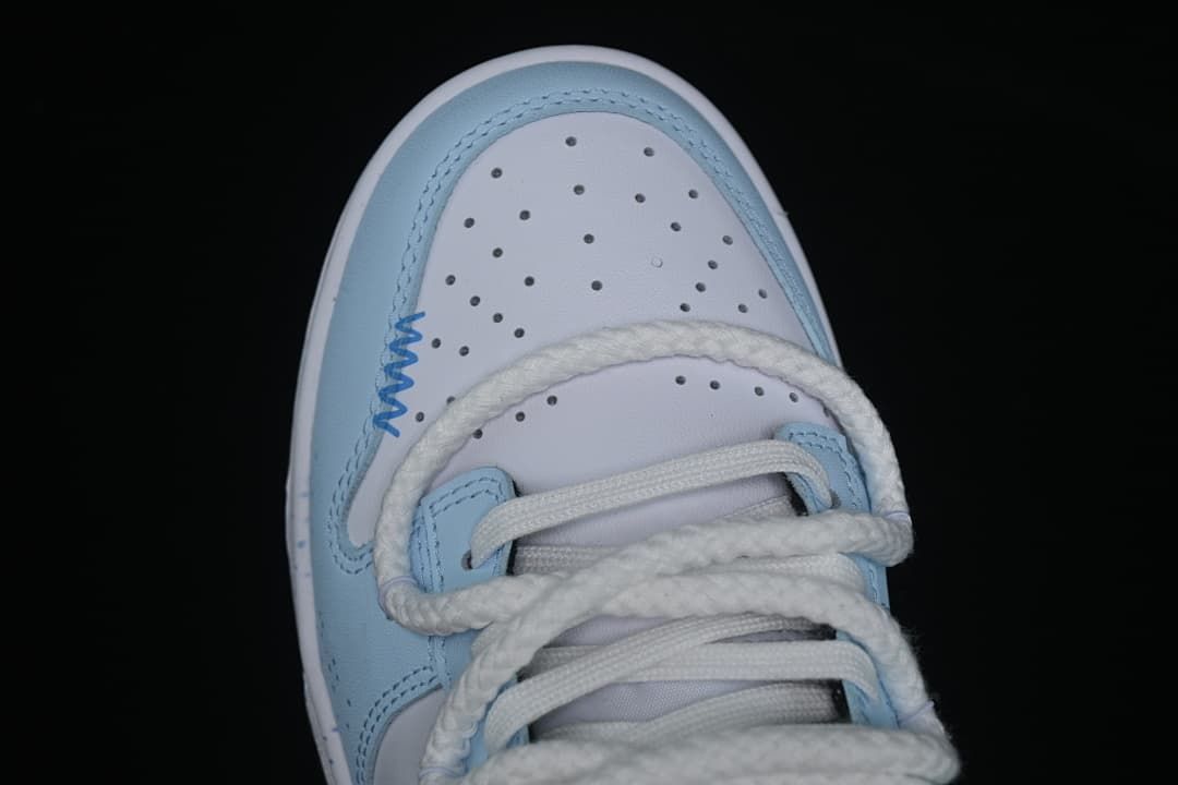 Top view of a perforated toe box with white and light-blue panels