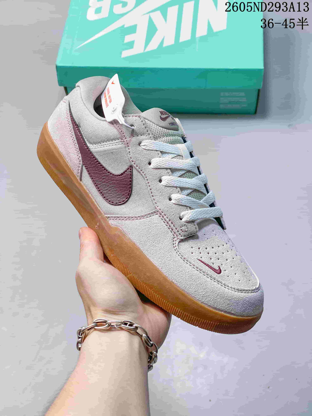 Angled view of a Nike SB Force 58 low-top with burgundy Swoosh and gum-colored outsole