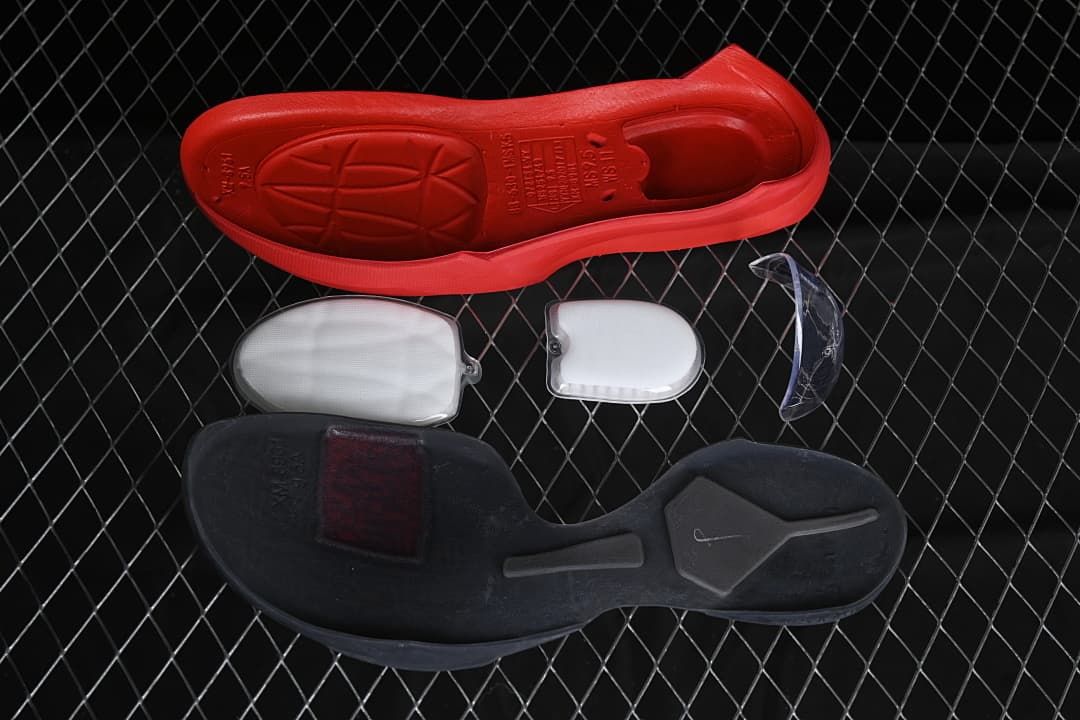 Outsole components and inserts shown beside the red shoe