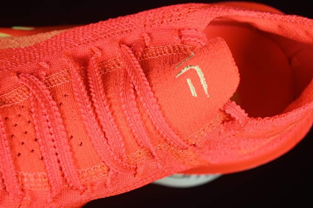 Close-up of the laces and tongue on the crimson shoe